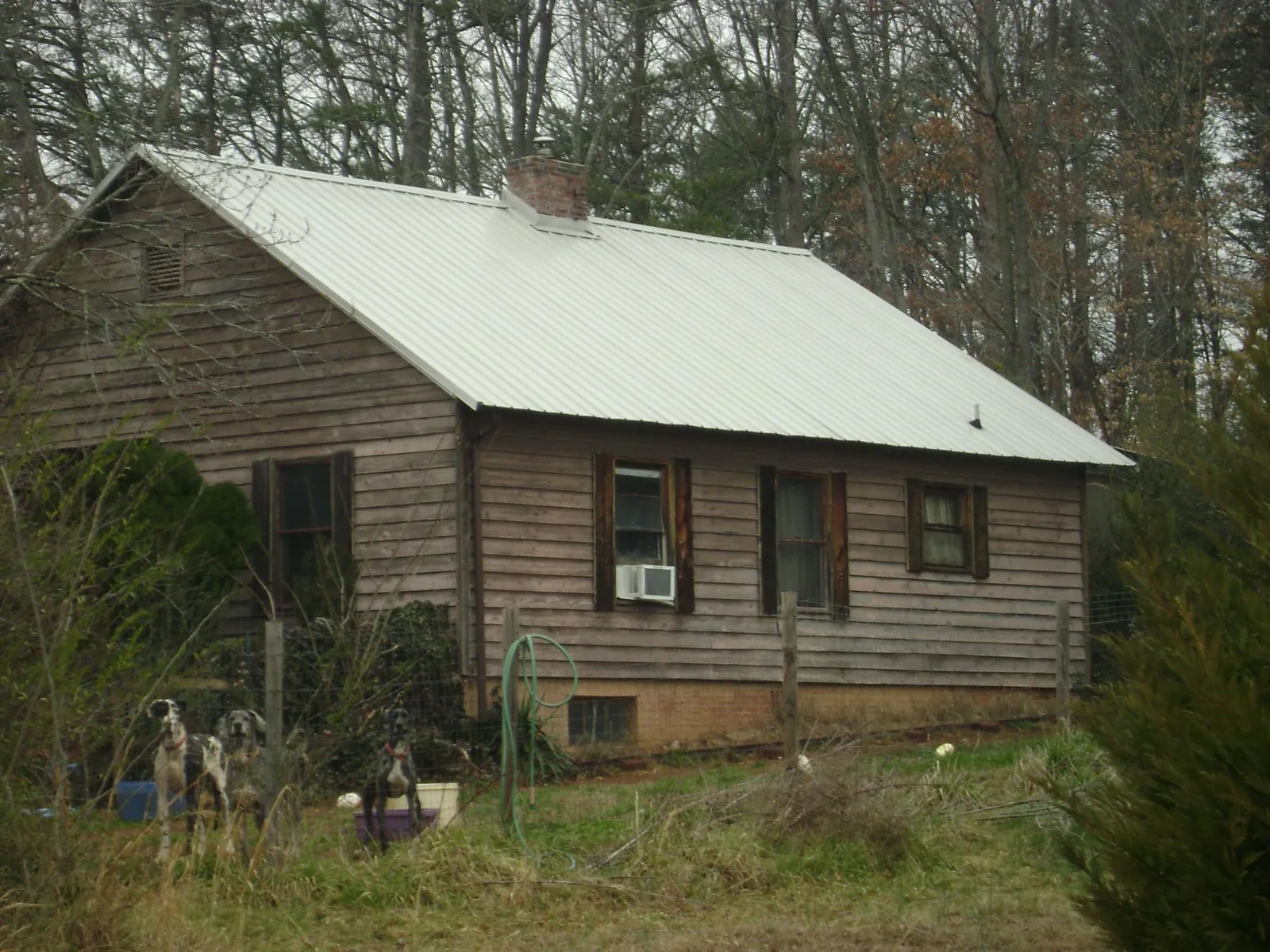 White metal roof on an old wood sided farmhouse, from a Metal Roof Installation job in Ludlow Falls